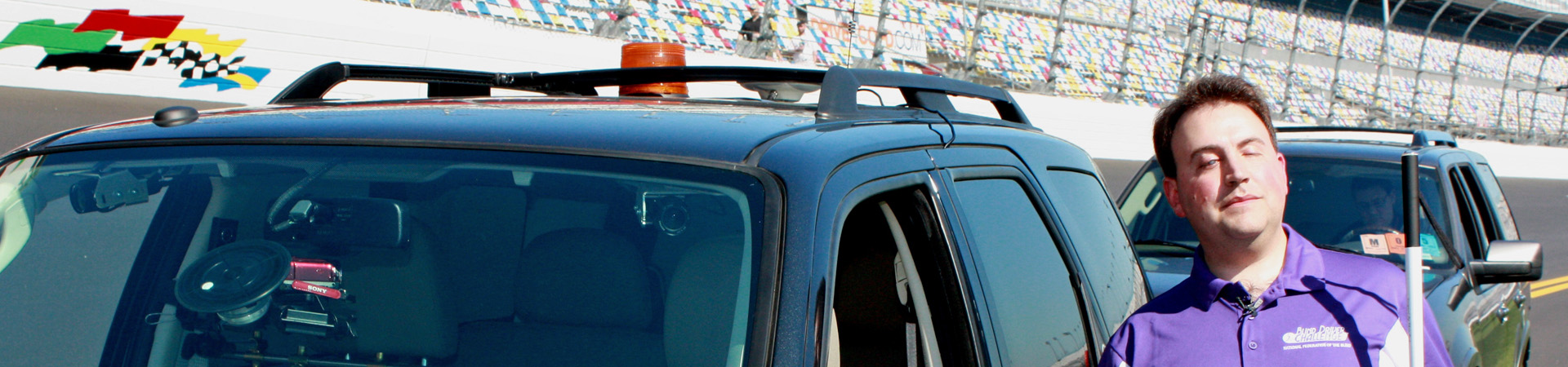 Mark Riccobono poses before his trip driving around the Daytona Race Track in the NFB’s blind driver car.