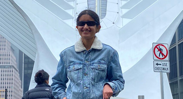 Mausam, an NFB member, smiles while visiting New York.